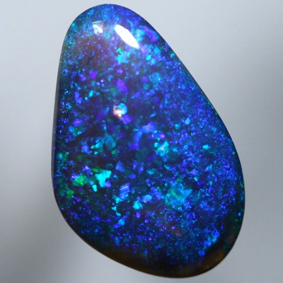 SOLID BLACK CRYSTAL OPAL A pinfire pattern of green and blue